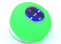 Green round electronic device with control buttons on a white background